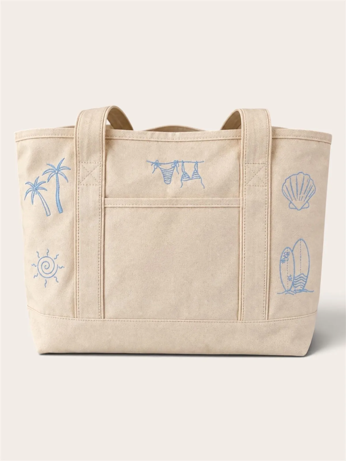 Canvas tote with palm trees, a sunshine swirl, a bikini clothesline, surfboards and a seashell stitched in light blue